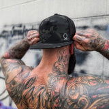 TDC SYMBOL BLACK CAMO FLAT BILL HAT