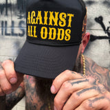 AGAINST ALL ODDS FLAMING RACING SKULL CURVED BILL BLACK HAT