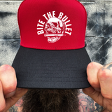 BITE BULLET RED BLACK CURVED TRUCKER HAT