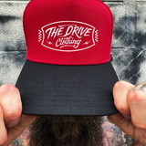 BADGE RED BLACK CURVED TRUCKER HAT